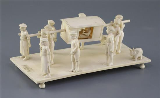 A 19th century Indian carved ivory group of a nobleman being carried in a sedan chair, attended by servants, 9in., height 3.75in.